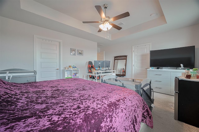 452 Long Beach Bay Dr, Katy, TX 77493 - bedroom featuring light colored carpet, a tray ceiling, freestanding refrigerator, and ceiling fan