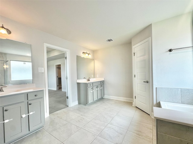 452 Long Beach Bay Dr, Katy, TX 77493 - bathroom featuring two vanities and a bath