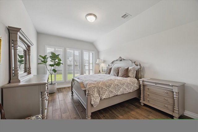 bedroom featuring visible vents, baseboards, dark wood-type flooring, and vaulted ceiling