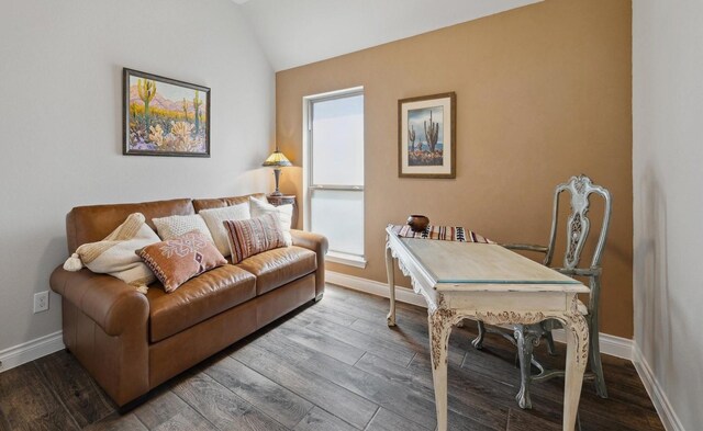home office featuring baseboards, lofted ceiling, and wood finished floors
