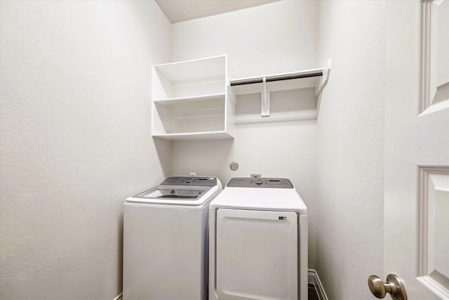 clothes washing area featuring washer and dryer and laundry area