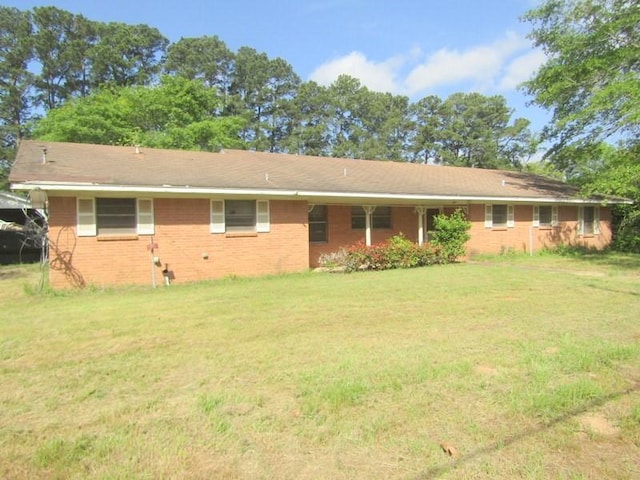 509 N Olive St, Grapeland, TX 75844 - ranch-style home featuring brick siding and a front lawn
