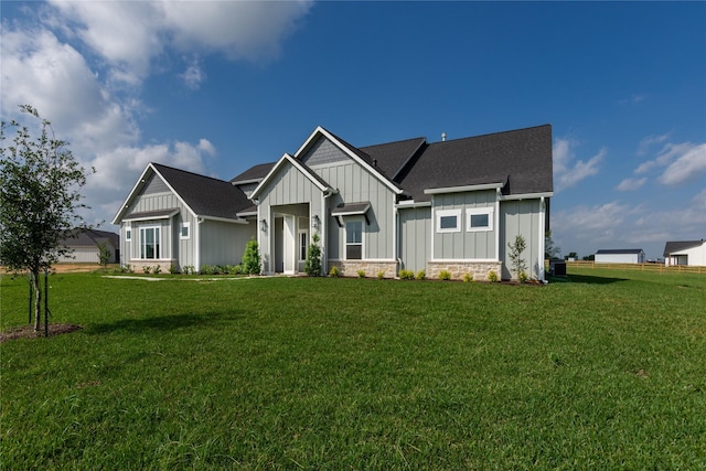 modern inspired farmhouse with board and batten siding and a front yard