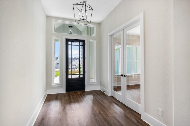 entryway featuring a chandelier, french doors, baseboards, and dark wood-style floors