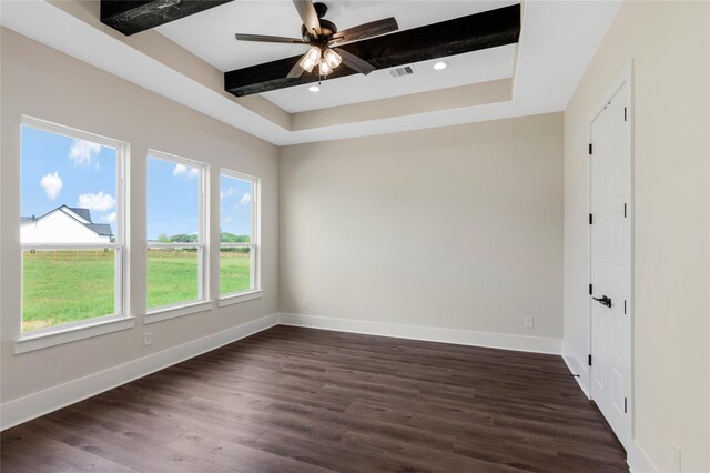 empty room with a ceiling fan, baseboards, dark wood-style flooring, and visible vents