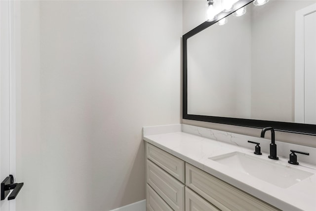 bathroom featuring baseboards and vanity