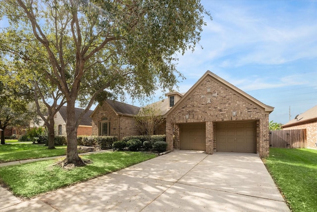 25630 Creston Meadow Dr, Richmond, TX 77406 - view of front of house featuring an attached garage, brick siding, driveway, and a front lawn