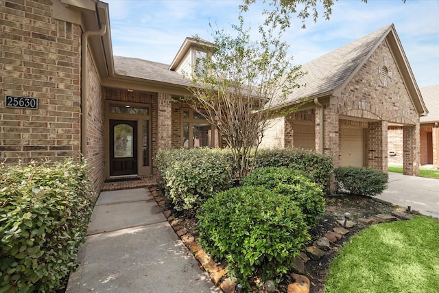 25630 Creston Meadow Dr, Richmond, TX 77406 - entrance to property featuring brick siding, driveway, a garage, and roof with shingles