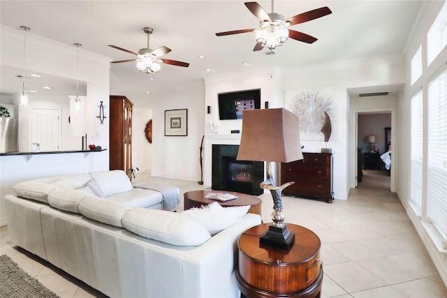 living area with a ceiling fan, a glass covered fireplace, light tile patterned floors, recessed lighting, and baseboards