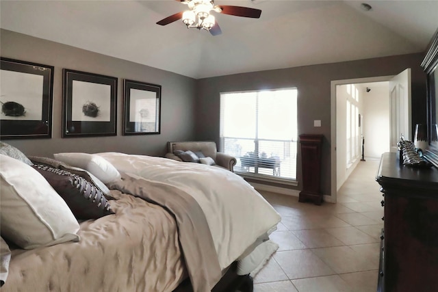 bedroom with lofted ceiling, light tile patterned flooring, and ceiling fan