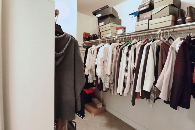 walk in closet with tile patterned floors