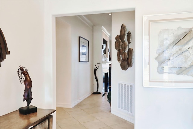 hall featuring light tile patterned floors and baseboards