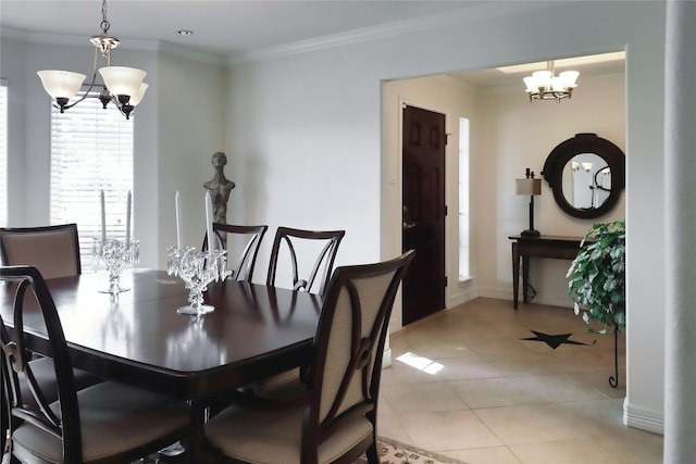dining room featuring a chandelier, ornamental molding, light tile patterned flooring, and baseboards