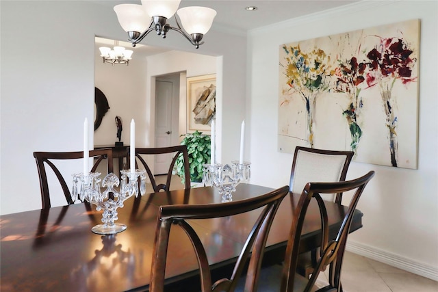 tiled dining space with a chandelier, ornamental molding, and baseboards