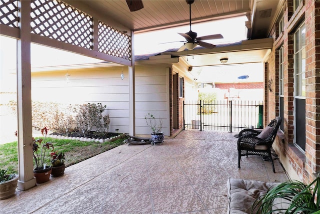 view of patio featuring ceiling fan and fence