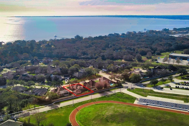 aerial view of residential area with a large body of water and property parcel outlined
