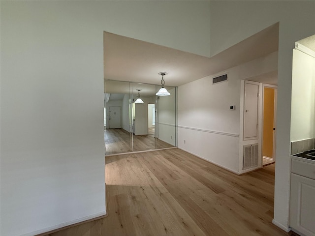 5711 Sugar Hill Dr Unit 62, Houston, TX 77057 - unfurnished dining area featuring light wood-type flooring, visible vents, and baseboards