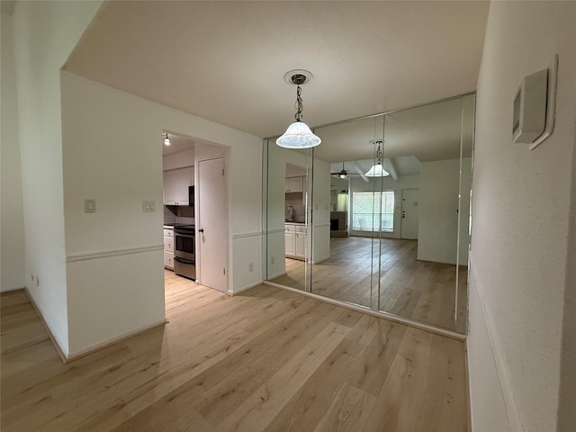 5711 Sugar Hill Dr Unit 62, Houston, TX 77057 - unfurnished dining area featuring light wood-type flooring, a ceiling fan, and a sink