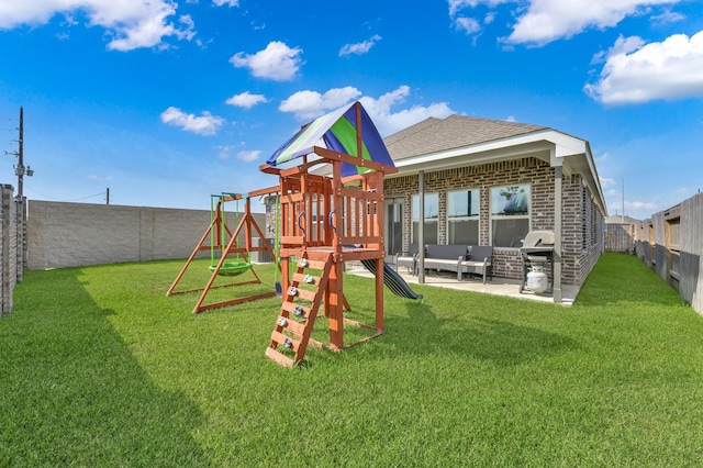 view of playground featuring a lawn, a fenced backyard, and a patio area