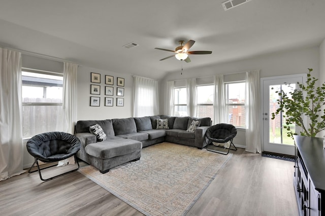 living room featuring ceiling fan, visible vents, and light wood-style flooring