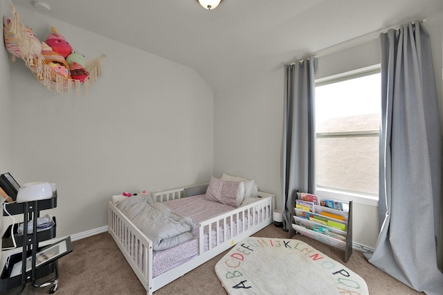 carpeted bedroom with vaulted ceiling, baseboards, and multiple windows