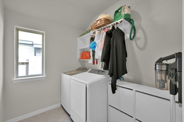 laundry area featuring baseboards, a healthy amount of sunlight, washer and clothes dryer, and laundry area