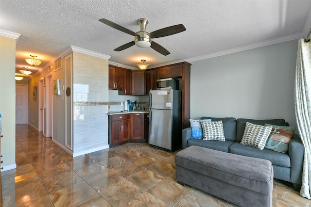 6102 Seawall Blvd Unit 155, Galveston, TX 77551 - kitchen with crown molding, open floor plan, ceiling fan, stainless steel appliances, and light countertops