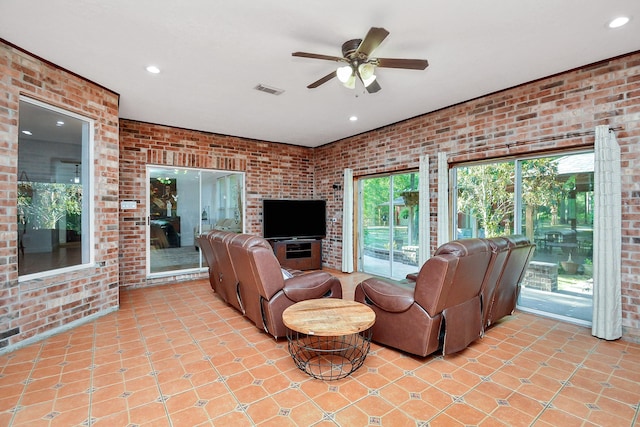 living room featuring brick wall, a ceiling fan, recessed lighting, and light tile patterned floors