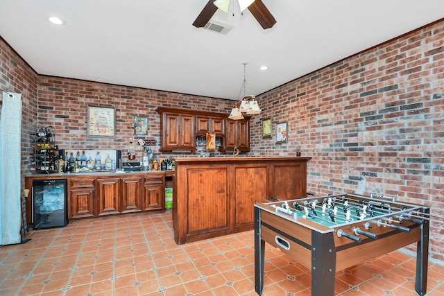rec room with beverage cooler, bar, brick wall, ceiling fan, and visible vents