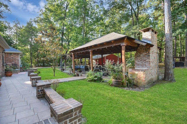 view of community with a gazebo, a yard, and a patio area