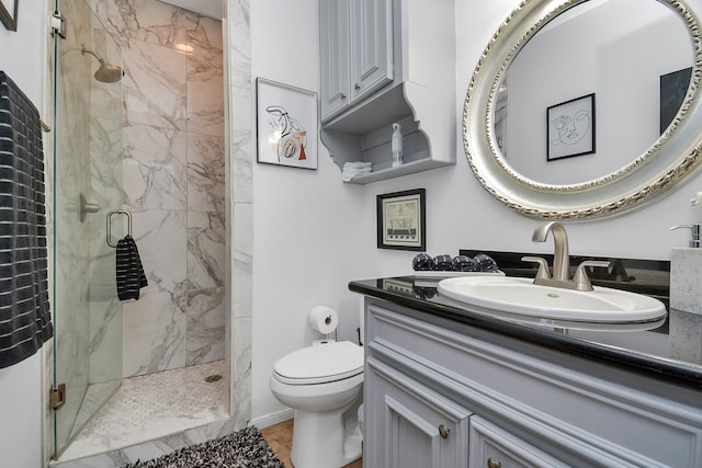 bathroom with toilet, vanity, and a marble finish shower
