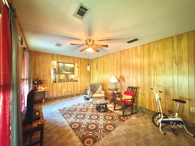 sitting room featuring a ceiling fan, visible vents, and carpet
