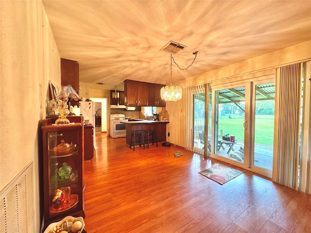 dining room featuring a chandelier, wood finished floors, and visible vents