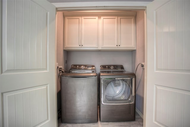 279 Capetown, Conroe, TX 77356 - laundry area with cabinet space and washing machine and dryer