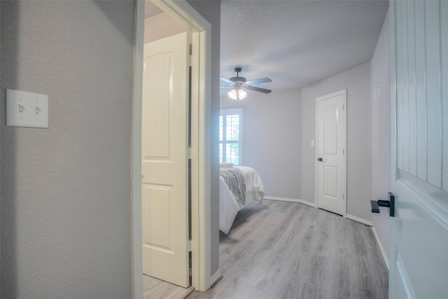 279 Capetown, Conroe, TX 77356 - bedroom with light wood-style flooring, baseboards, and a ceiling fan