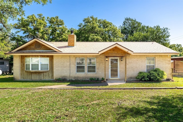 5233 N US Highway 183, Gonzales, TX 78629 - ranch-style home with brick siding, a chimney, and a front lawn