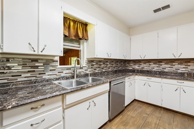5233 N US Highway 183, Gonzales, TX 78629 - kitchen featuring white cabinets, stainless steel dishwasher, a sink, visible vents, and decorative backsplash