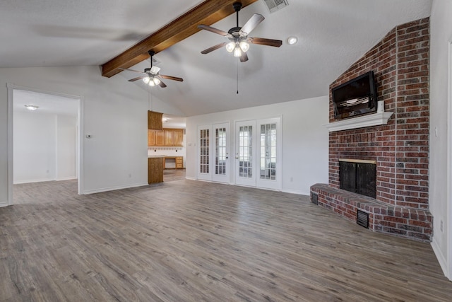 27 Westwood Dr W, Trinity, TX 75862 - unfurnished living room with wood finished floors, a ceiling fan, a fireplace, and baseboards