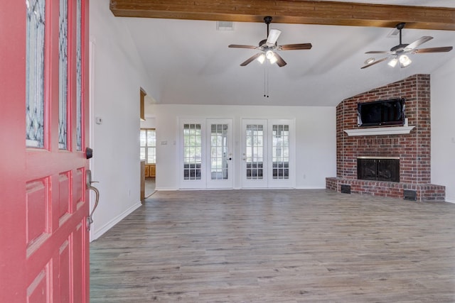 27 Westwood Dr W, Trinity, TX 75862 - unfurnished living room featuring wood finished floors, a ceiling fan, a brick fireplace, and baseboards