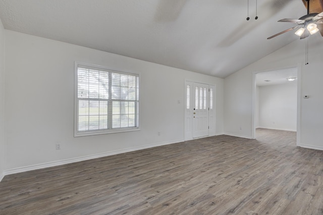 27 Westwood Dr W, Trinity, TX 75862 - unfurnished living room featuring a ceiling fan, wood finished floors, lofted ceiling, and baseboards