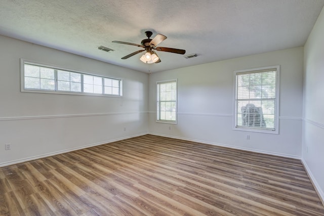 27 Westwood Dr W, Trinity, TX 75862 - empty room featuring wood finished floors, ceiling fan, baseboards, and a textured ceiling