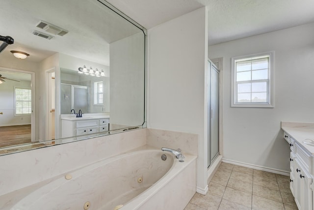 27 Westwood Dr W, Trinity, TX 75862 - bathroom with vanity, a stall shower, baseboards, a whirlpool tub, and tile patterned flooring