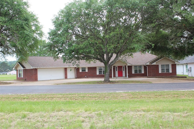 27 Westwood Dr W, Trinity, TX 75862 - single story home with concrete driveway, brick siding, and an attached garage
