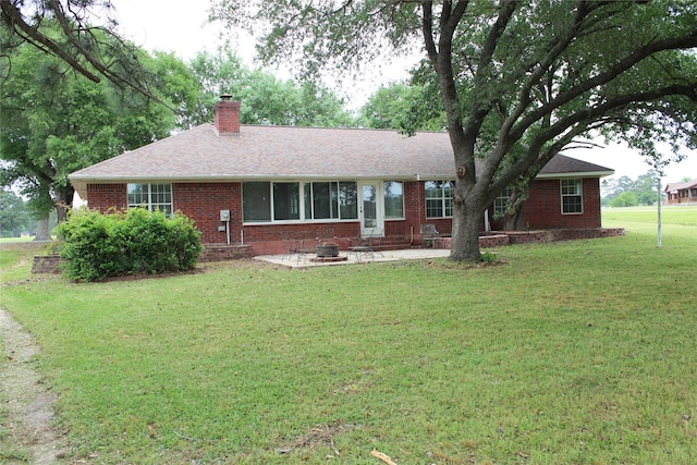 27 Westwood Dr W, Trinity, TX 75862 - ranch-style home featuring a chimney, brick siding, a front yard, and a shingled roof