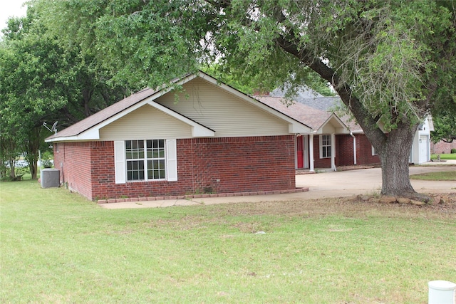 27 Westwood Dr W, Trinity, TX 75862 - ranch-style house with brick siding, concrete driveway, a front lawn, and central air condition unit