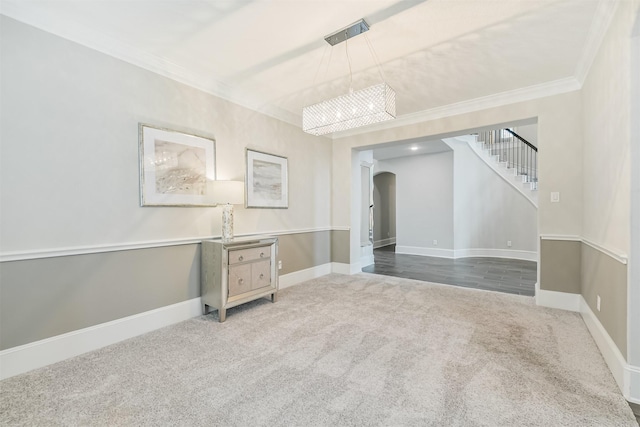 12107 Allington Cove Ln, Humble, TX 77346 - carpeted spare room featuring arched walkways, baseboards, an inviting chandelier, stairway, and crown molding