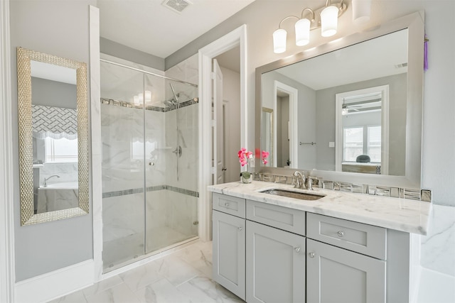 12107 Allington Cove Ln, Humble, TX 77346 - full bathroom with visible vents, marble finish floor, a shower stall, ceiling fan, and vanity