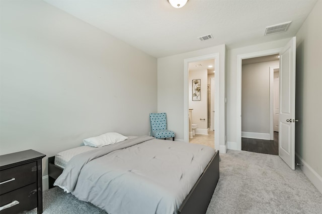 12107 Allington Cove Ln, Humble, TX 77346 - carpeted bedroom featuring connected bathroom, baseboards, and visible vents