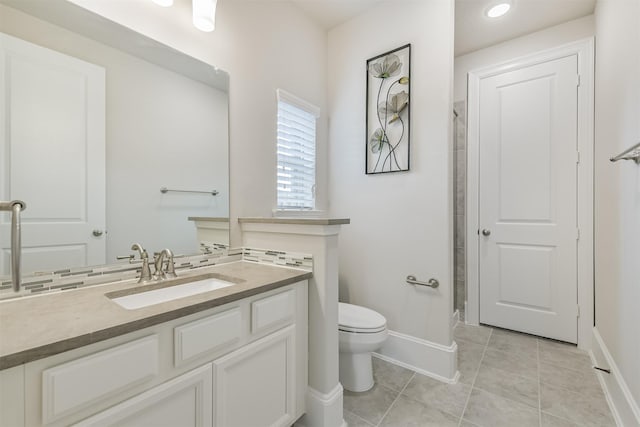 12107 Allington Cove Ln, Humble, TX 77346 - bathroom with tile patterned floors, toilet, vanity, baseboards, and walk in shower