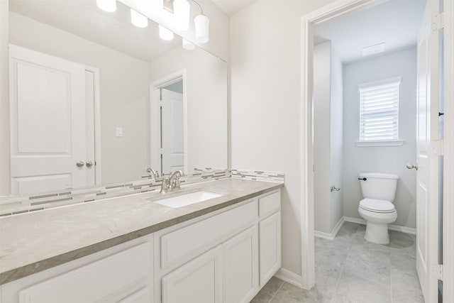 12107 Allington Cove Ln, Humble, TX 77346 - bathroom featuring baseboards, toilet, vanity, and tile patterned floors